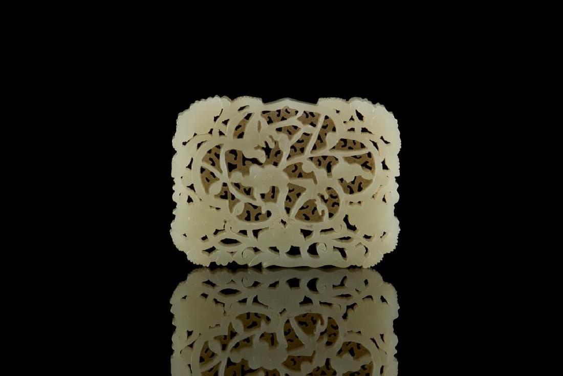 CHINESE JADE CARVED OPENWORK PLAQUE: Overall in even pale celadon tone. Carved in Ming style with birds and flowers against a fretwork background. Size: 5 x 7cm (2 x 2 3/4 in.)