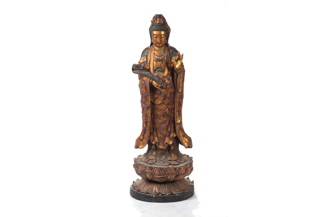 LARGE CHINESE POLYCHROME & GOLD WOOD GUANYIN: Standing on a double lotus throne with left hand raised and right hand holding a ruyi scepter. H. 106cm (41 1/2 in.)