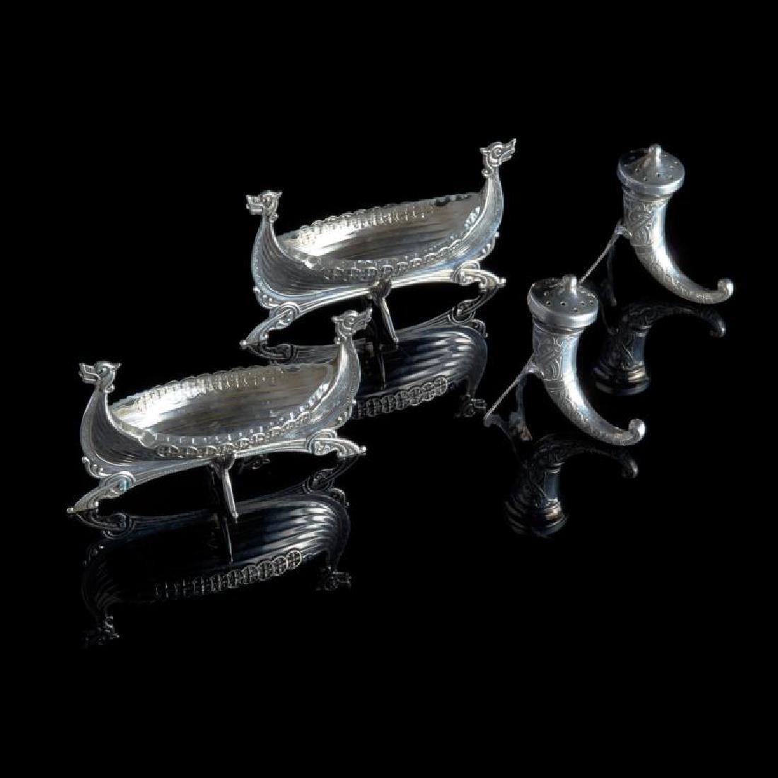 Two pairs of Norwegian salts and peppers: The salt cellars in the form of Viking long boats with clear glass liners. Marked for 830 standard. The pepper casters in the form of Scandinavian drinking horns. Marked for 925. 100g. weighable.L. of