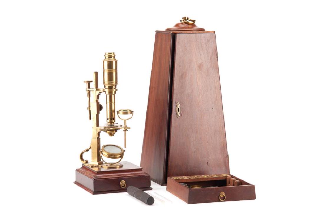 Georgian English microscope: A brass George III compound microscope with multiple lenses, mounted on a mahogany base and in a fitted mahogany case. Includes various parts and bone mounted samples in a faux shagreen case.Dollond, 