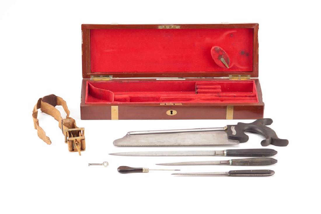 Early 20th C English field surgeon's kit: A field amputation set supplied by the Medical Supply Association of Edinburgh with some tools by J. Ellis & Son. Including bone saw and surgical knives. In a brass bound mahogany fitted box withan em
