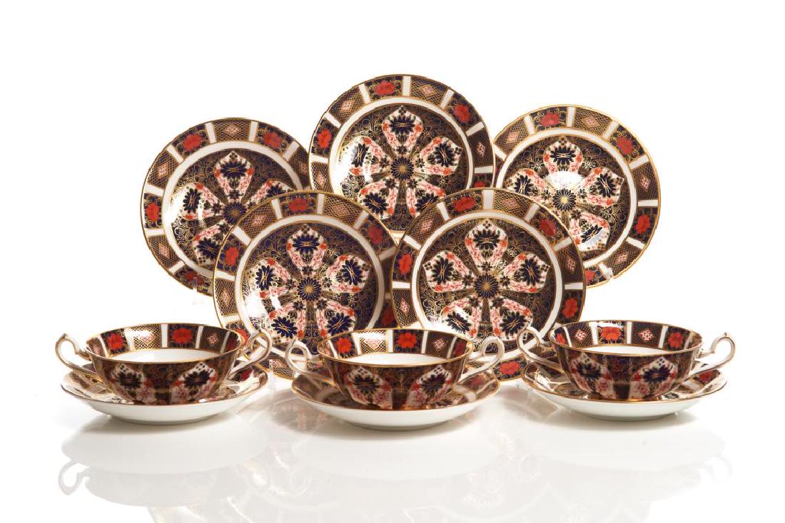 12 Royal Crown Derby Old Imari 1128 cream soups: and stands, second half 20th C. Bowl across handles 6 1/8in. Saucer 6 1/2in in diameter.