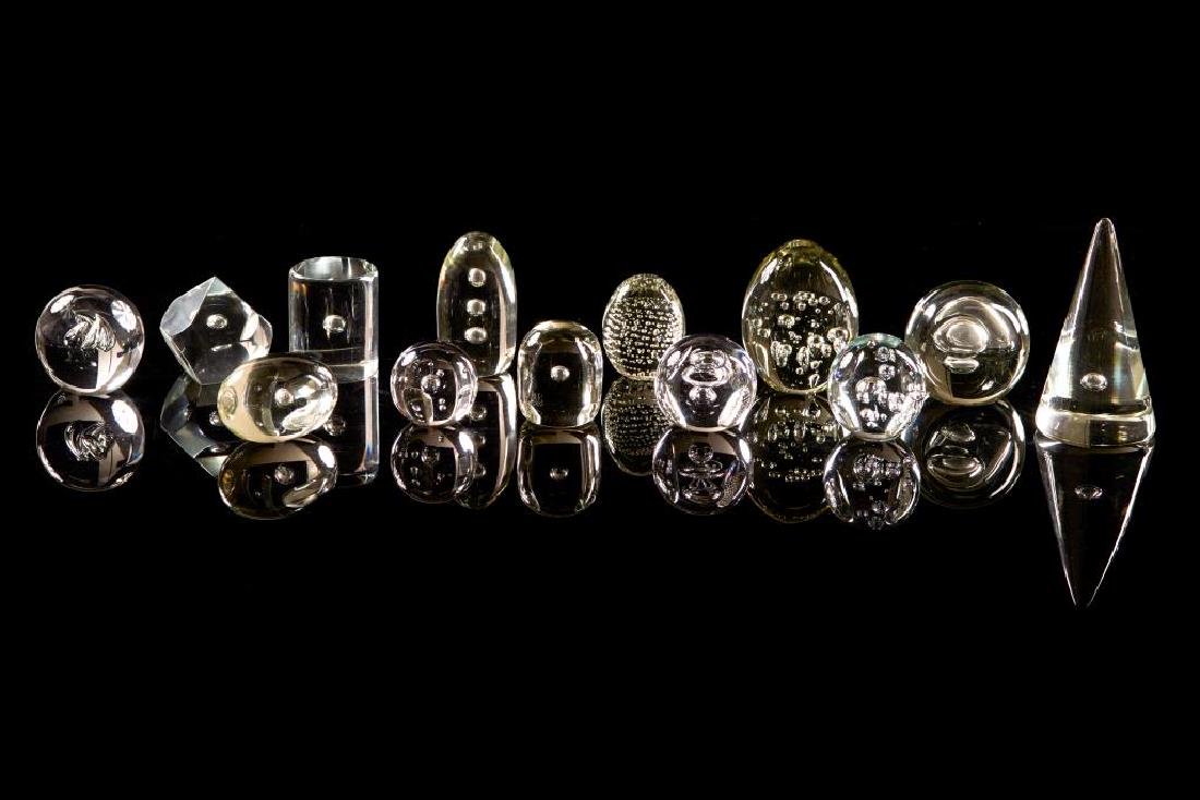 Assorted clear glass paperweights: Some marked, including one by Simon Pearce and a Scandinavian Holmegaard paperweight.