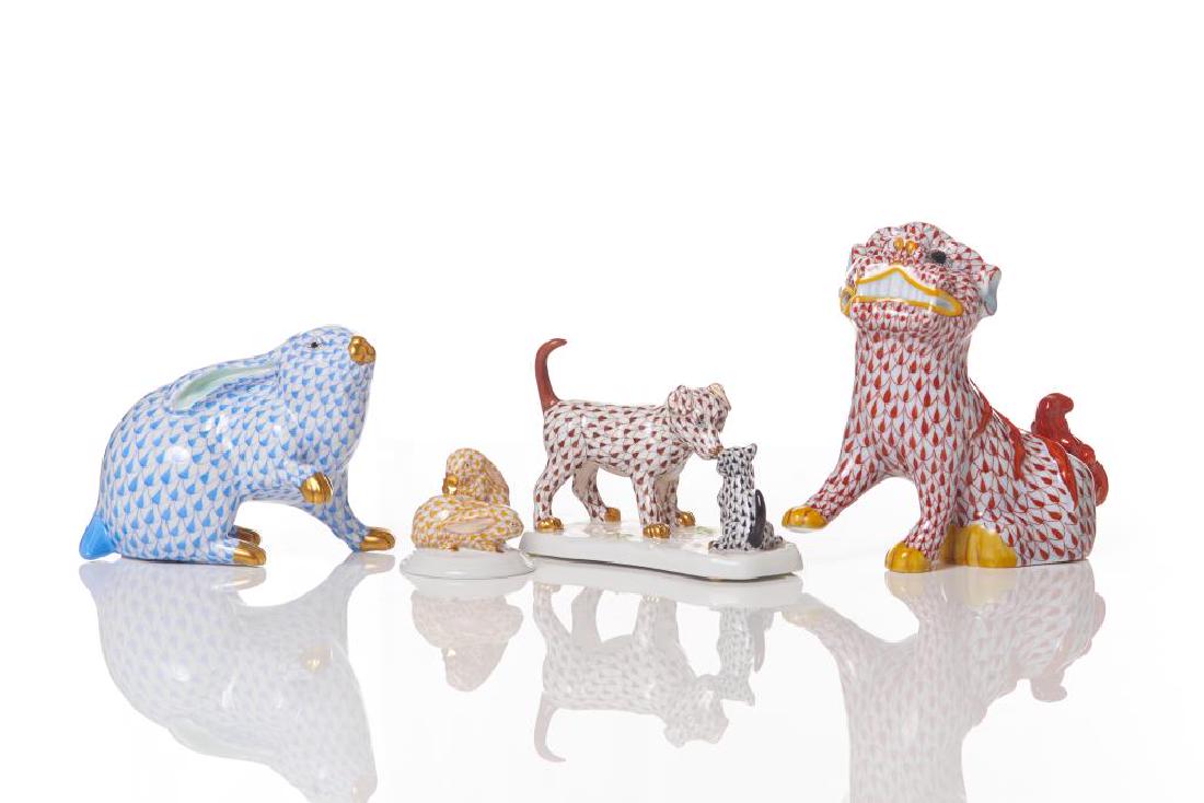Four Herend porcelain fish scale animal figures: Including a pair of rabbits in butterscotch yellow, a sitting rabbit in blue, a fu dog in rust orange, and a dog and cat in chocolate brown and black. H. of foo dog: 15.2 cm (6 in.)