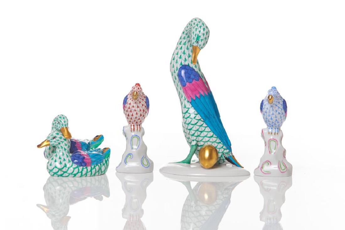 Four Herend porcelain animal figures: Including a pair of ducks in green, a goose with a golden egg in green, and two parrots (one blue and one rust orange). All marked to bases. H. of goose: 19.1 cm (7 1/2 in.)