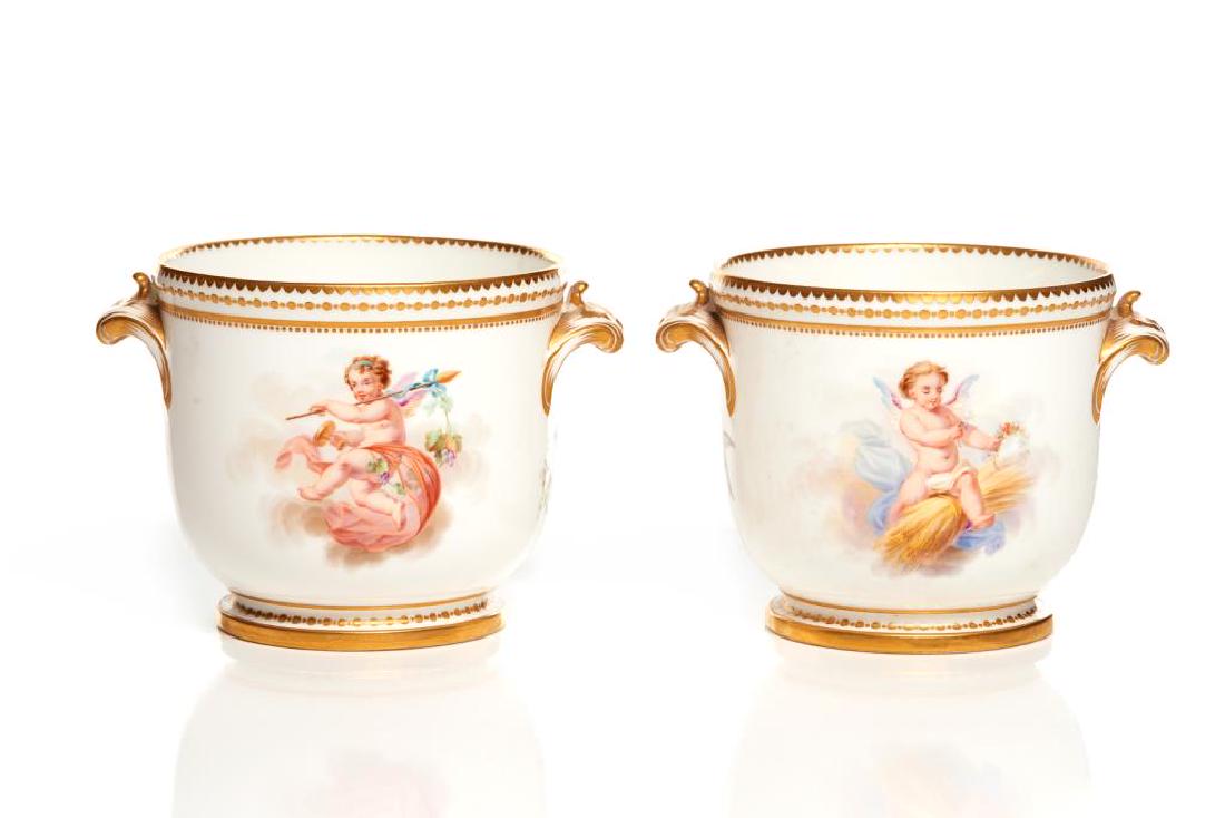 Pair of English hand painted porcelain cache pots: Decorated with scenes of putti and birds, and gilt accents and borders. Minton mark to base. Early 19th C. H. 10.2 cm (4 in).