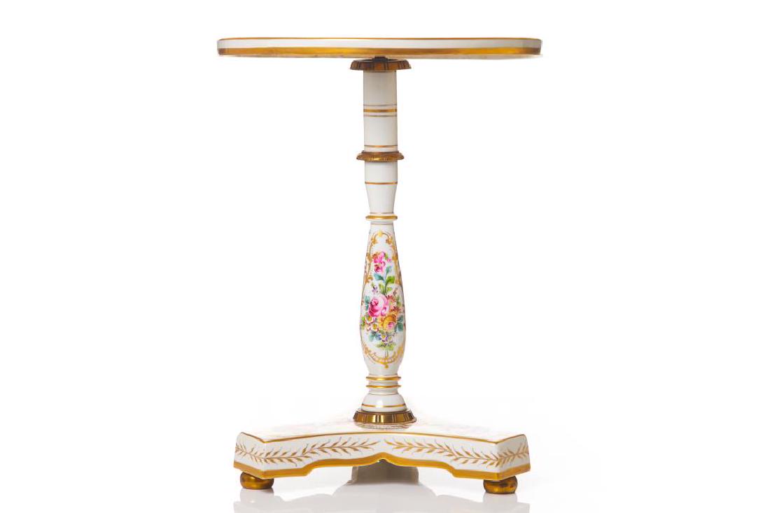 Antique French Limoges porcelain side table: Marked and labeled Made in France. Dia. 38.1 cm (15 in.) H. 50.8 cm (20 in.) Chip to underside of table.