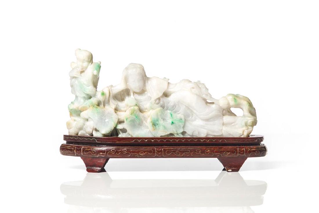 CHINESE JADEITE CARVED RECLINING GUANYIN GROUP: Carved with a reclining Guanyin with a child attendants and water lilies. 20th C. L. 24cm (9 1/2 in.)