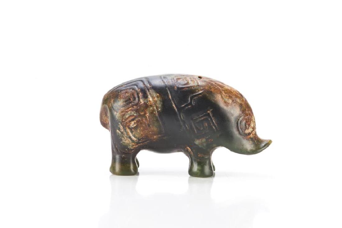 CHINESE ARCHAISTIC JADE PIG FIGURE: Overall in green tone with russet inclusions. Carved as a pig with archaistic scrolls to back in the Shang dynasty manner. L. 5cm (2 in.)