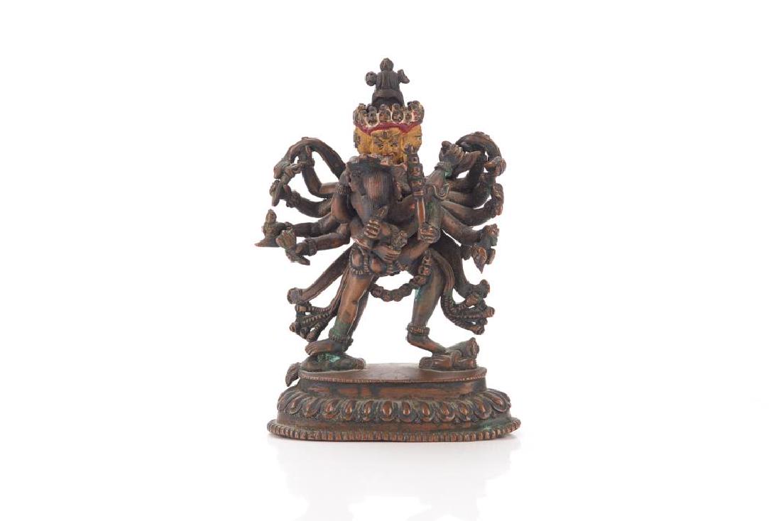 19TH C. NEPALESE BRONZE TANTRIC MANJUSHRI: Bronze with gold and red painted face and head, cast as twelve-armed and four-headed. Each hand holding a ritual implement. Standing on lotus platform. H. 13.5cm (5 1/4 in.) Weight: 424g.
