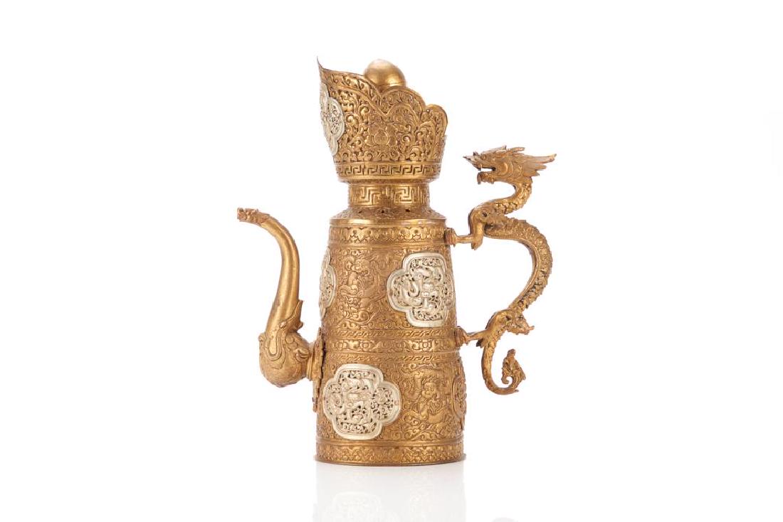 19TH C. TIBETAN GILT & SILVER CEREMONIAL EWER: Large tall ewer with monk's hat form top of gilt copper body with silver plaques. Body in pressed repousse style with dragons and floral patterns/ Silver plaques to body. Dragon form handle andspout. 