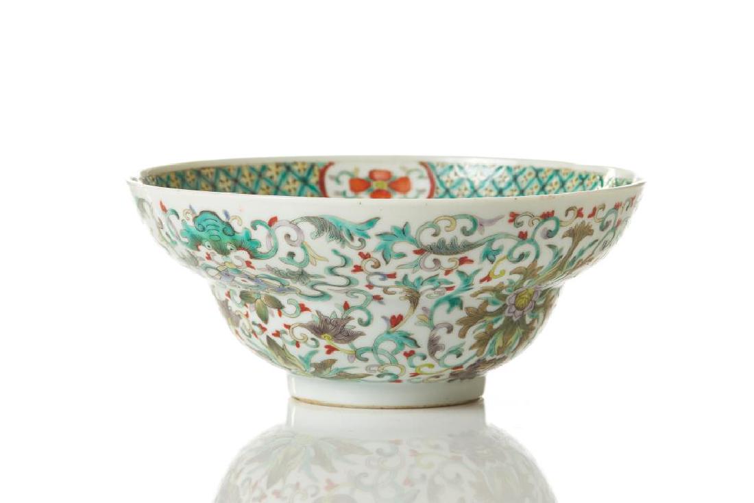CHINESE FAMILLE VERTE PORCELAIN BOWL: Painted with lotus sprays and bats. Bottom of interior painted in iron red with five bats surrounding a Shou symbol. Base with six character red Kangxi mark, 19th C. Dia. 17cm (6 3/4 in.) H. 7cm (2 3/