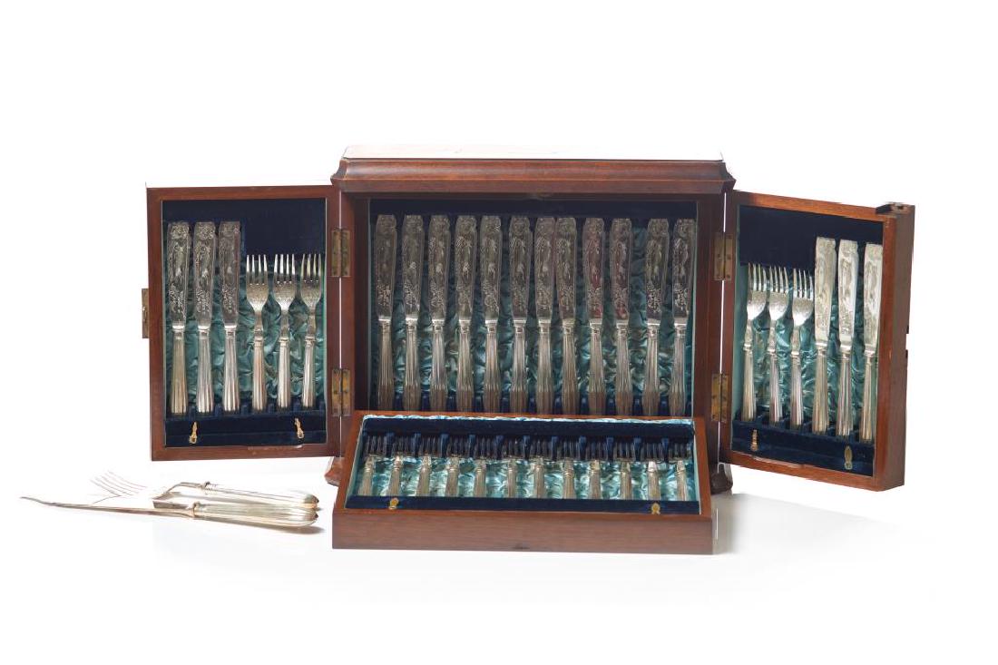 38 piece cased English silver plate fish set: Set includes 18 fish knives with ornate fish and foliate decoration to the blades, 18 forks, and a serving knife and fork. All in a lined free standing case with empty cartouche to top. H. ofcase: 33 