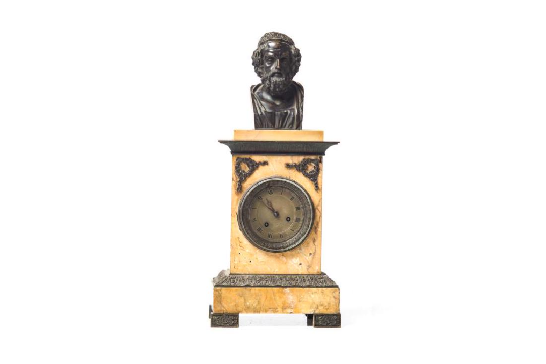 French marble and bronze figural mantel clock: Topped with the bust of a Classical male figure, possibly Plato, decorated with floral, foliate and wreath accents. Nicod, 25 Rue des Sts. Peres to face of clock. H. 53.3 cm (21 in.)Condition Report C