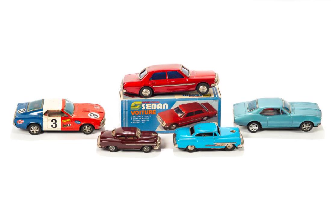 Five tin friction and battery toy cars: Taiyo battery Rusher Mach 1 Mustang and Chevrolet Camaro, Shanghai Friction Sedan in box and two vintage friction cars, Desoto and another