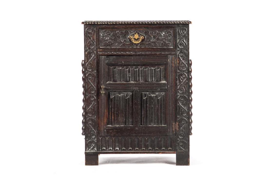 An early English carved oak cabinet: In the Tudor manner with slat carved single front door flanked by scroll panel decoration and single drawer, 17th/18th C. 31 1/4 x 24 x 17 1/4 in.