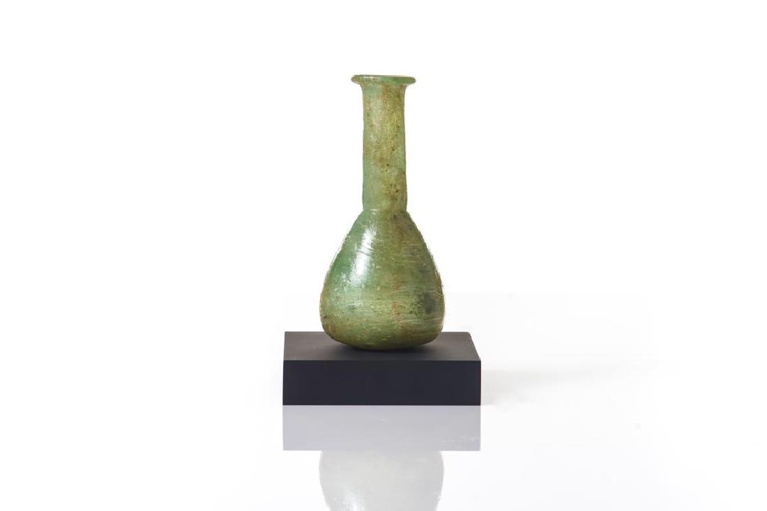 Ancient green Roman glass vase: Or vial form. 1st-3rd C CE. Provenance: Noele and Ronald Mele, Ancient Works of Art, 1985.