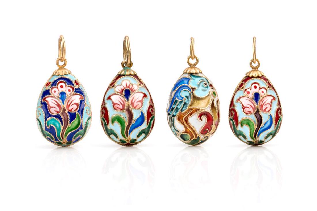 Four Russian silver & enamel egg pendants: Stamped with .88. Each with a floral design and gilt washed finish.