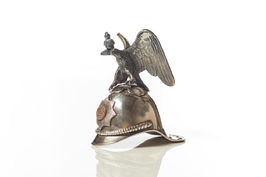 Russian silver novelty vodka cup: In the form of a cavalier helmet with perched eagle above, rose gold crest emblem on front of cap, with Russian hallmarks, 108g. H 3 1/2in.