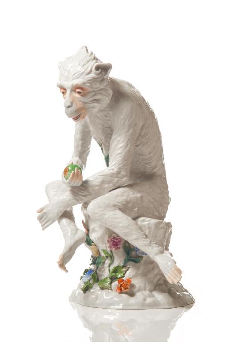 Dresden porcelain monkey: Seated on a tree stump with applied floral sprays, holding an apple. Dresden marks to base. H. 16 1/2 in. Tips of four fingers and tips of four toes havebeen restored.