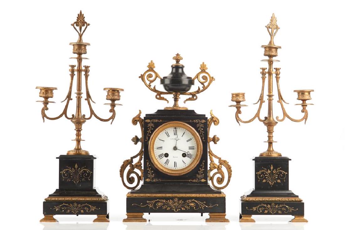Three piece slate and gilt bronze clock garniture: Aesthetic design with etched gilding in slate. The enamelled dial marked for S. P. Kleiser, Toronto. H. of clock: 14 1/2 in.