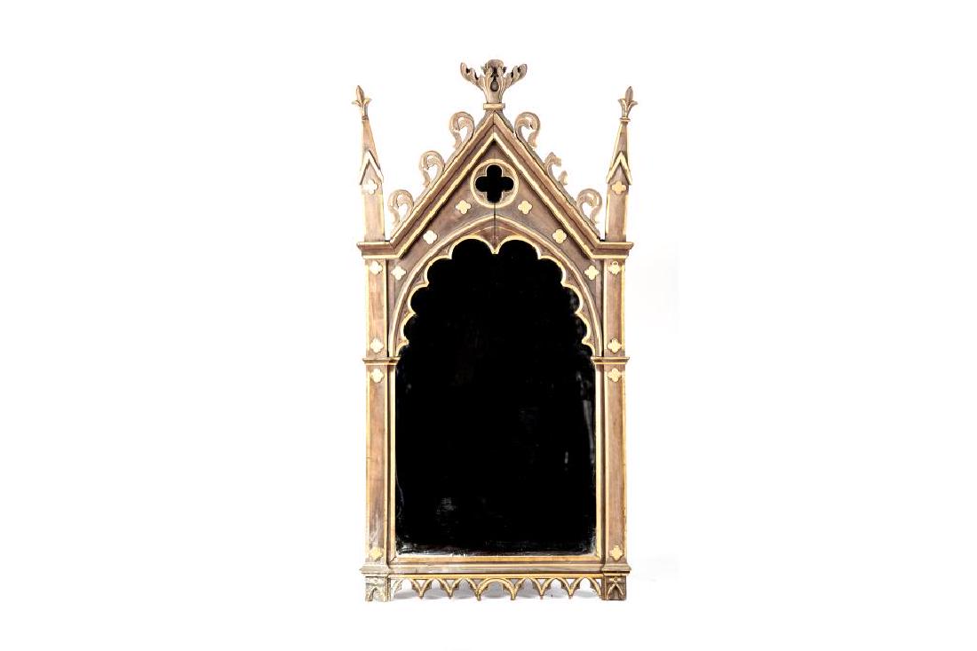 Gothic influenced carved wood framed mirror: Wood stain with parcel gilt details. H. 76 in. W. 36 in.