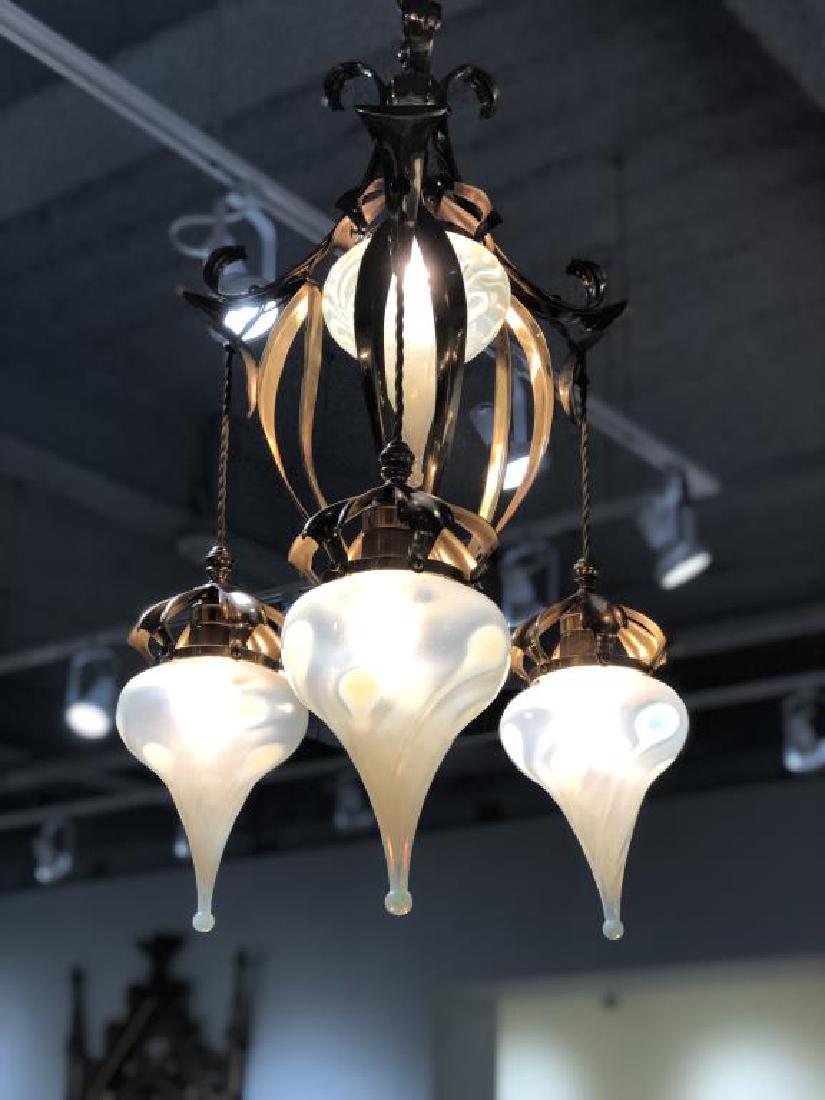 Art Nouveau glass & brass hanging fixture: Central brass fixture with three foliate drops, the four yellow iridescent opaline tear drop shades.