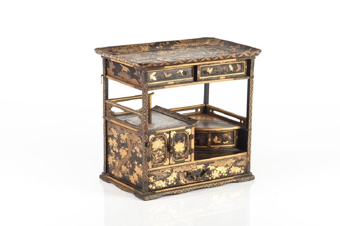 JAPANESE MINIATURE INLAID GILT LACQUER TANSU CHEST: Black lacquer ground with bronze inlay and gold paintings. Top painted with paradise bird in a garden landscape. Side painted with flowers and butterflies. Meiji period. Size: 17.5 x 25.5 x24cm (7 x 1