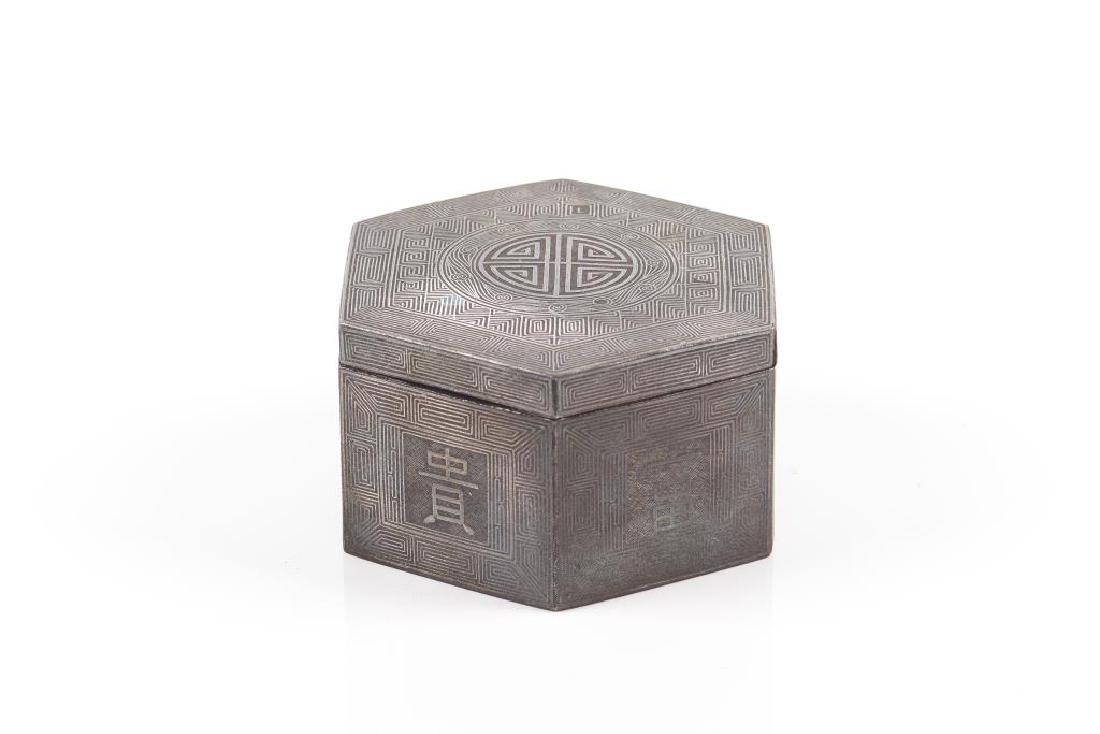 KOREAN HEXAGONAL IRON BOX WITH SILVER INLAY: Each side decorated in silver wire with a key scroll border and a character to center. Joseon dynasty, 19th C. L. 11cm (4 1/4 in.) H. 6.5cm (2 1/2 in.)