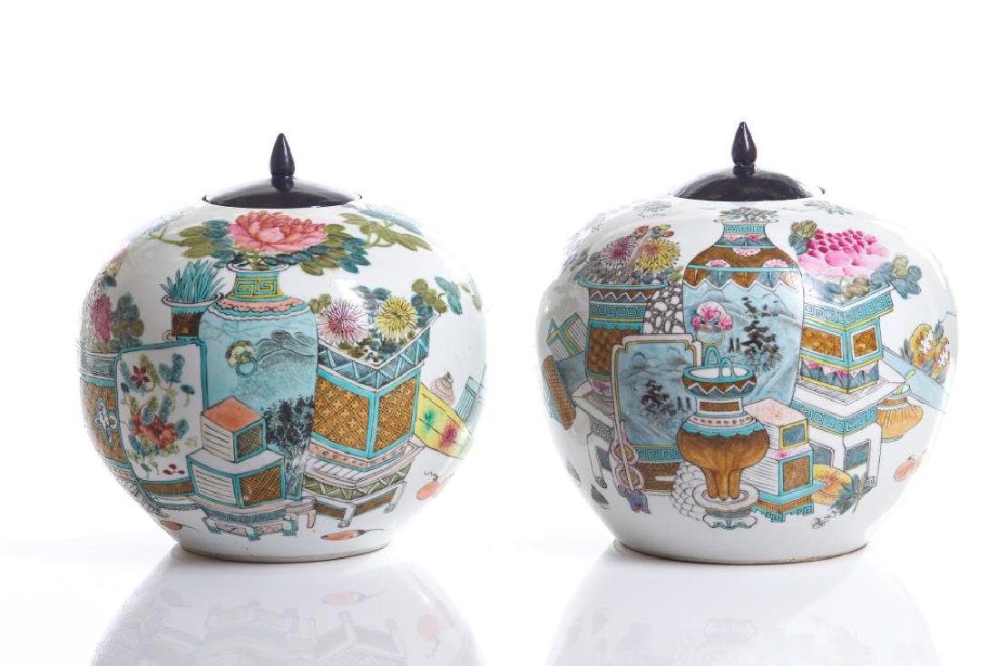 TWO CHINESE FAMILLE ROSE ENAMEL PORCELAIN JARS: Painted with hundred antiques motifs with flowers and fruits. Both with calligraphy inscription to reverse, one signed Dai Yucheng, the other signed Zhong Shan and cyclically dated to 1898. Late Qing