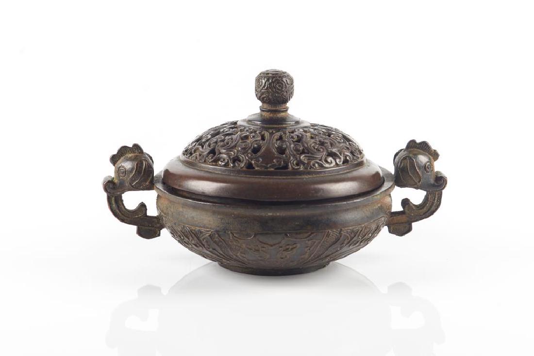 CHINESE BRONZE CENSER WITH COVER: With archaistic taotie decoration to exterior of censer and a pair of animal head form handles. Cover with openwork floral decoration and a Base cast with Yun Gu 雲谷 mark. Censer dia. 15c