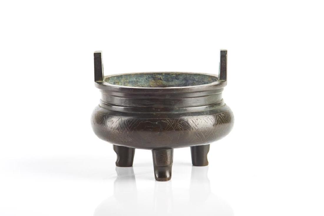 CHINESE SILVER INLAID BRONZE TRIPOD CENSER: The circular censer with upright post handles to top, body with silver inlaid bamboo garden and scroll decorations. Base with silver inlaid Shisou 石叟 mark. Height to top of handle" 10.7c