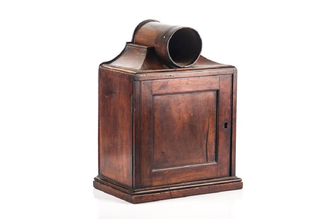 SMALL MAHOGANY TABLE TOP BALLOT CABINET: Mahogany small cabinet with set of drawers, concealed by wooden door. Three drawers total, 2 small (each 13.5cm wide) and one larger (27cm wide). All drawers with round wooden handles.Possibly for lot