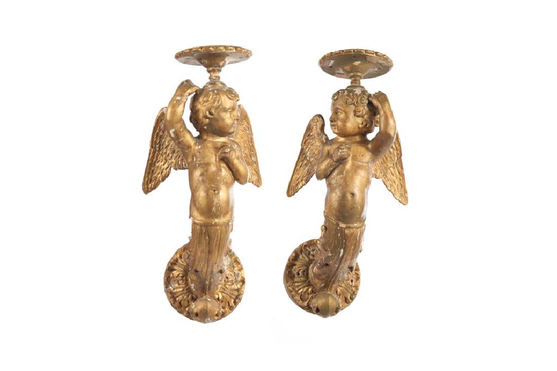 PAIR OF CHERUB WALL BRACKETS: Gilt gesso on wood. H. 50.1cm (19 3/4 in.) From the collection of Senator Nicole Eaton, Eaton Family, Toronto.