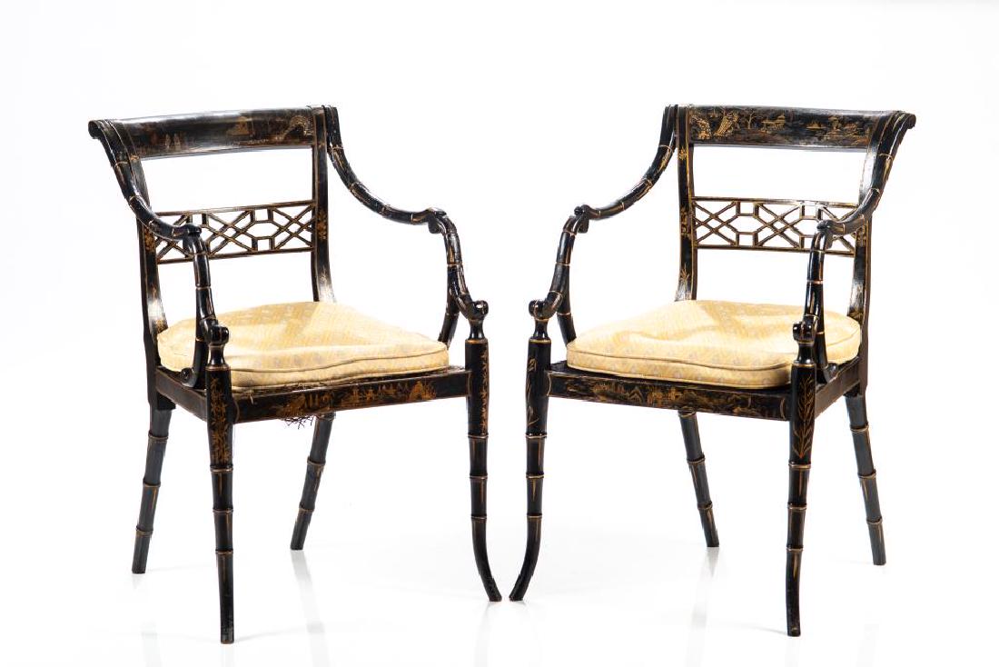 PAIR OF EBONIZED REGENCY ARMCHAIRS: Fretwork backs, caned seats, overall gilded finish on a black lacquer ground.
