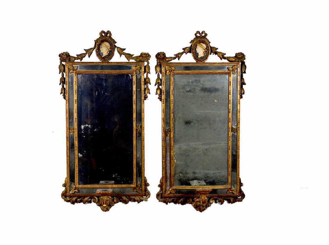 PAIR OF ANTIQUE ENGLISH GILT FRAMED MIRRORS: Each accented with a classical painted portrait medallions and candle sconce. 18th C. 41.5 x 80.5 cm (16 x 31 3/4 in) From the estate of June Bramall, Oakville, Ontario, Canada.