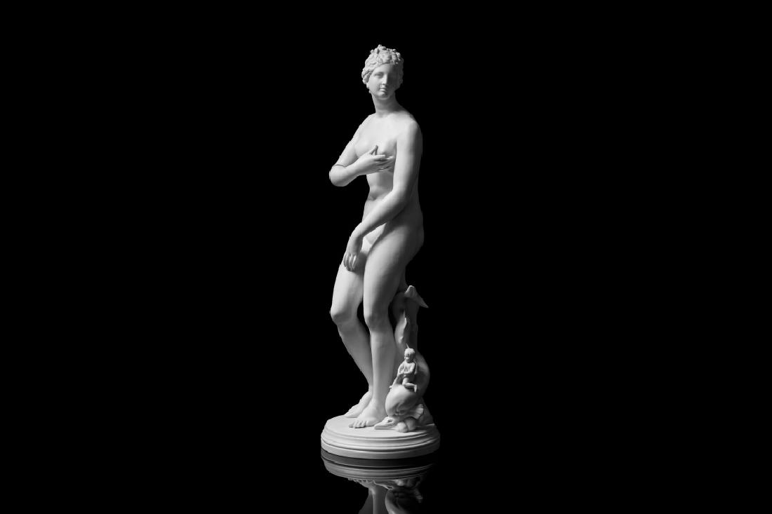 CLASSICAL NUDE VENUS BLANC DE CHINE SCULPTURE: Depicted with a sea creature and baby behind her on a circular mount. H. 58 cm (22 3/4 in) Condition on right arm, missing index finger and condition evident on baby.