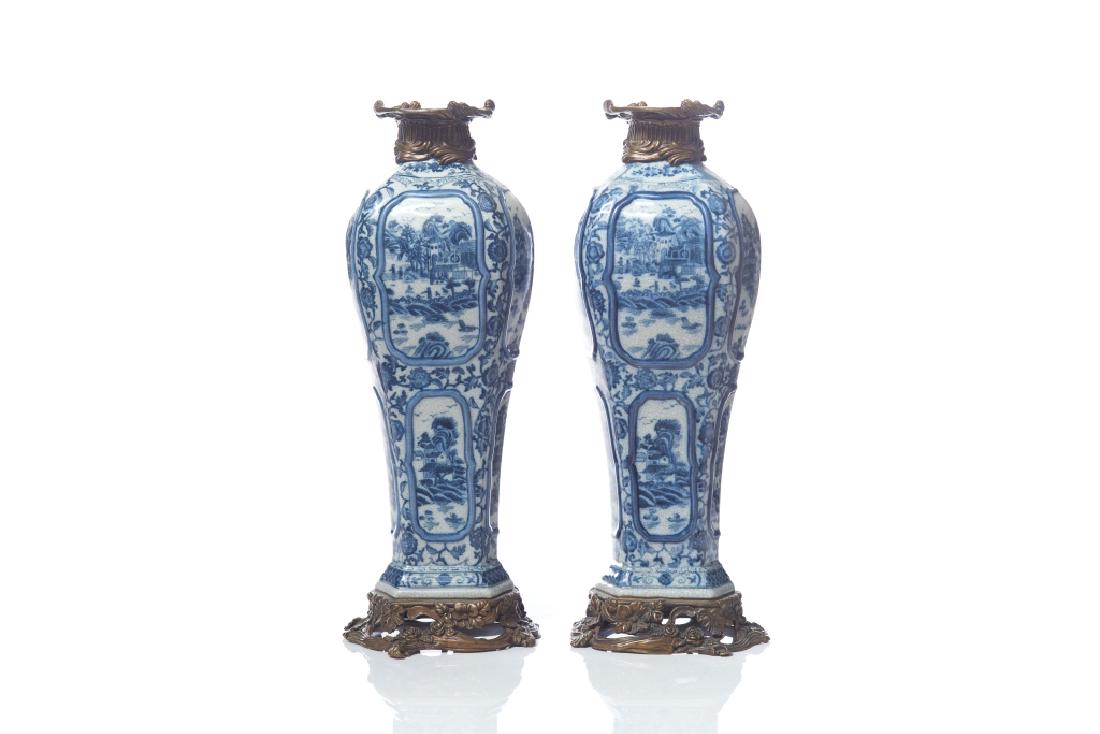 PAIR OF BLUE AND WHITE CRACKLE PORCELAIN VASES: French 19th century, inscribed with W.L. 1895 mark to base. With ormolu base and neck. Each vase consisting of 8 chinoiserie panels with floral motifs surrounding. H of each 50 cm (19 5/8 in)
