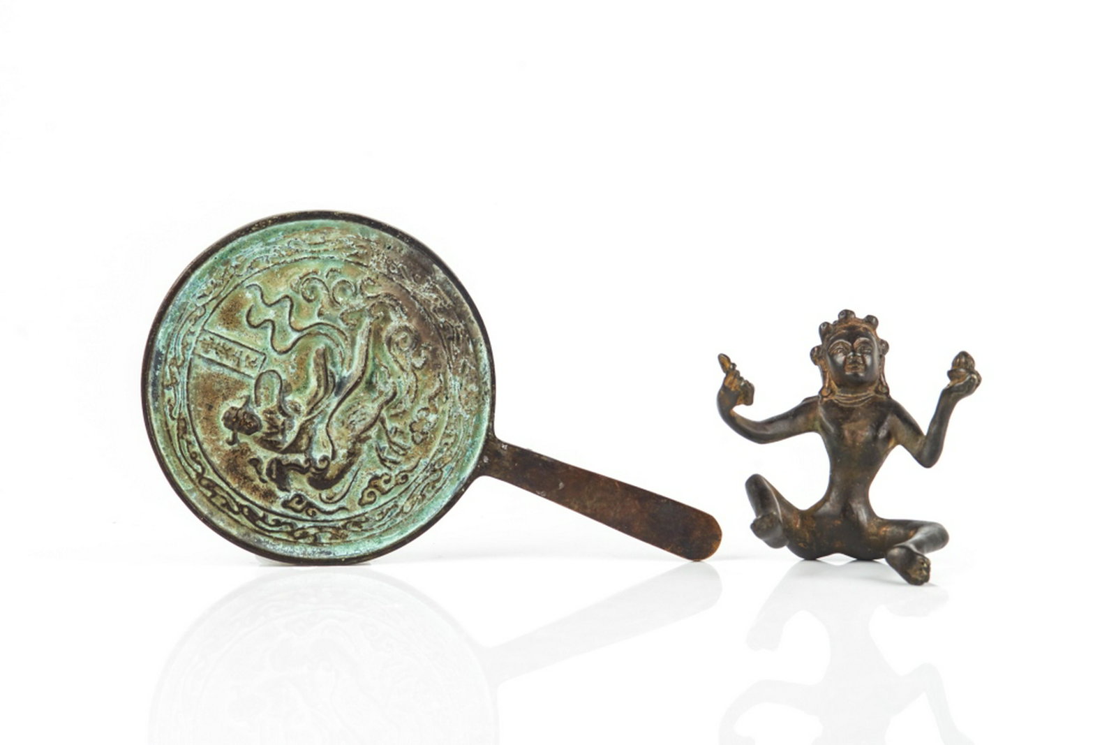 CHINESE BRONZE BUDDHIST FIGURE & HAND MIRROR: One of a bronze seated bodhisattva figure holdig ritual implement in each hand. The other of a bronze hand mirror cast with a phoenix riding scene to one side. Height of mirror: 18cm (7 in.) Height of
