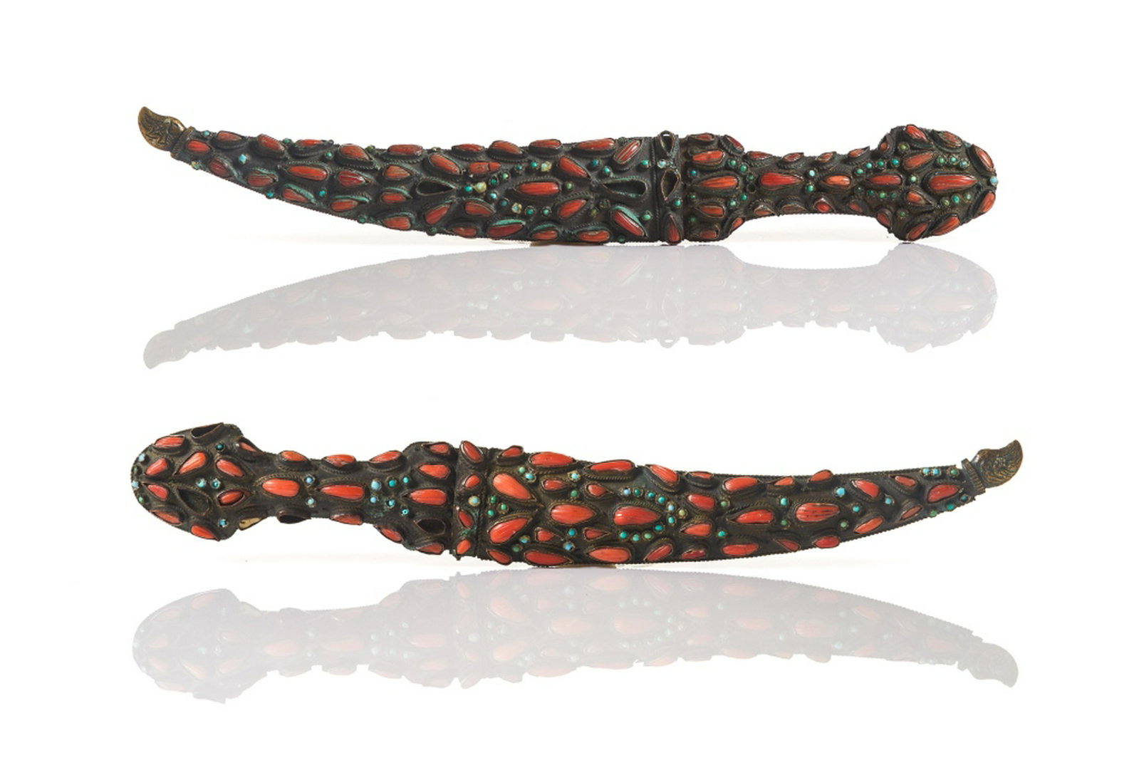 TWO OTTOMAN CORAL TURQUOISE INLAID STEEL DAGGERS: The Jambiyya dagger with double edged steel blade inlaid in gold to top of blade with scrolling vines and inscription. The sheath and hilt mounted to one side with drop form coral and turquoise caboch