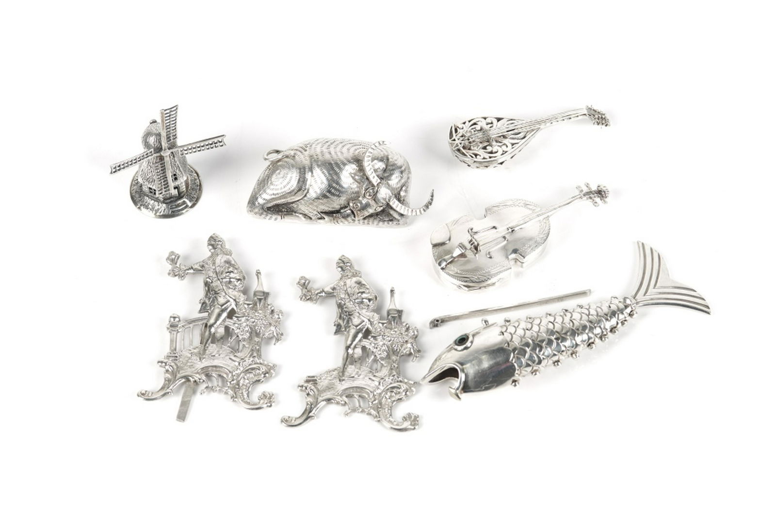 GROUP OF SILVER & SILVERPLATED FIGURES: Including a Mexican silver fish bottle opener (marked 925), a silvered resting bull, two silver string instruments (one snuff box), a Dutch windmill, and two place card or menu holders of standing fig