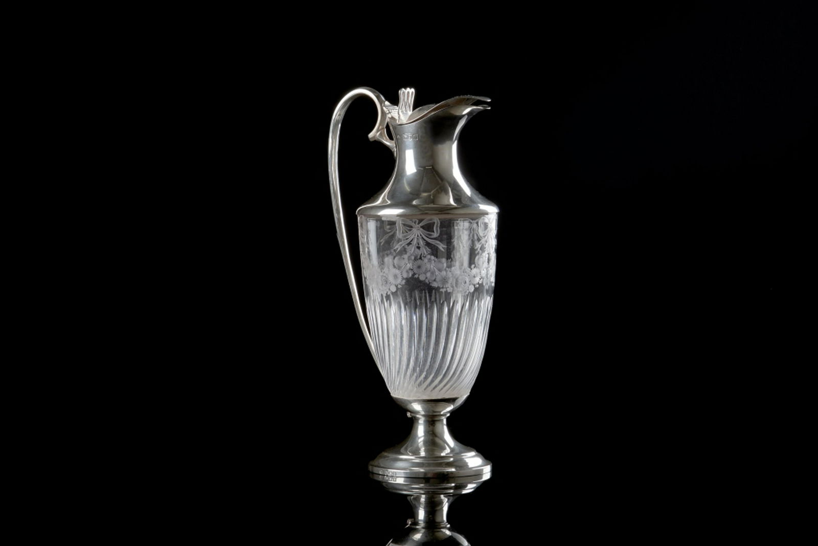 ENGLISH SILVER & ETCHED GLASS EWER: Or claret jug. Glass etched with ribbon and floral swags. Sterling silver base, handle, and lid with a hinged top. William Hutton & Sons Ltd, London, 1897. H. 28.3 cm (11 1/8 in.)