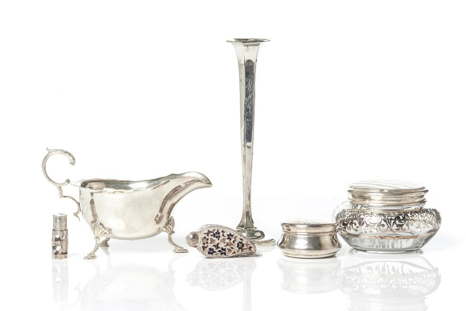 GROUP OF SILVER DRESSER BOXES & SAUCE BOAT: Group comprising three dresser boxes, one small Mexican silver scent bottle, and one standing monogrammed bud vase. Sauce boat marked William Hutton & Sons, Ltd, Birmingham, 1908, standing on three fe