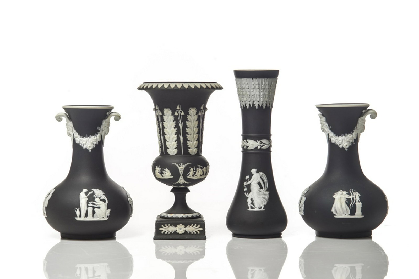 LOT OF ASSORTED BLACK WEDGWOOD JASPERWARE: Four pieces in total including a bottleneck vase, two double handled vases, and one footed urn form vase on square base. H. of tallest 20 .5 cm (8 in)