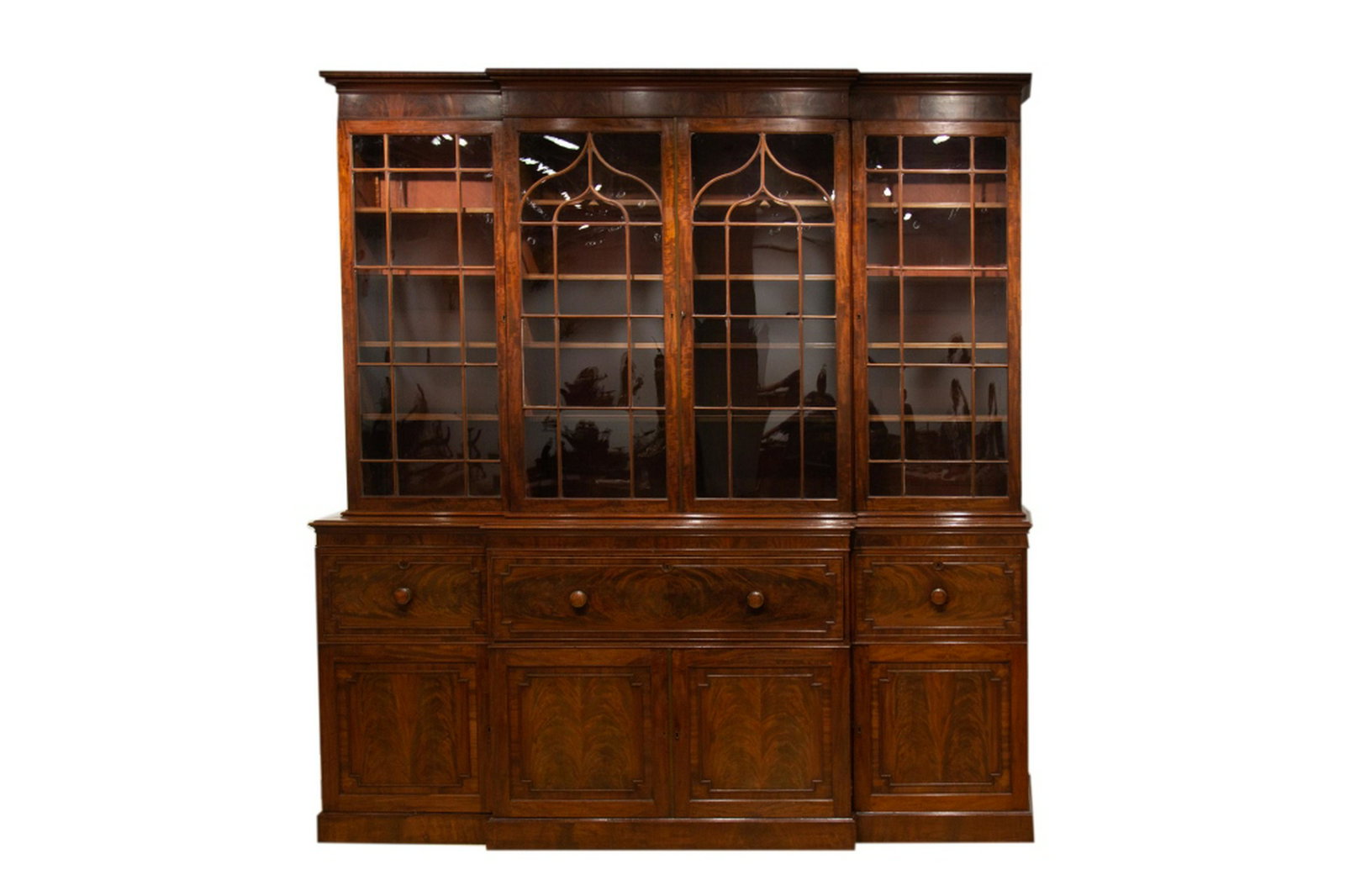 LATE REGENCY MAHOGANY BREAKFRONT: In the Georgian manner. With four glazed doors, centre drawer with fitted desk. H. 104 1/2 in. W. 97 1/2 in.