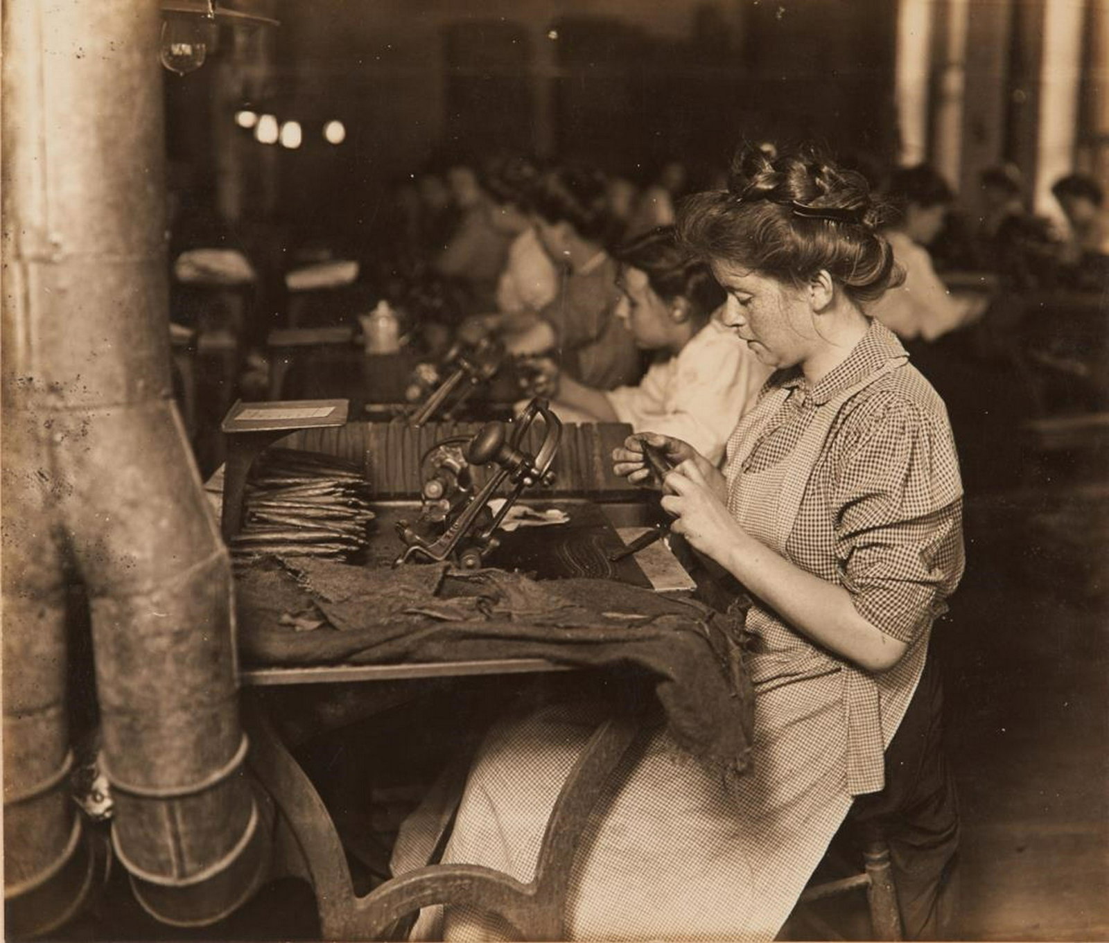 LEWIS WICKES HINE (American, 1874-1940): Making Pittsburgh Stogies (from the Pittsburgh Survey 1907-1908) Gelatin silver print Typewritten title beneath. Numbered 212 Size: 5 x 5.6 in. Provenance: Collection of Clarence McKenzie Lewis, Jr. (