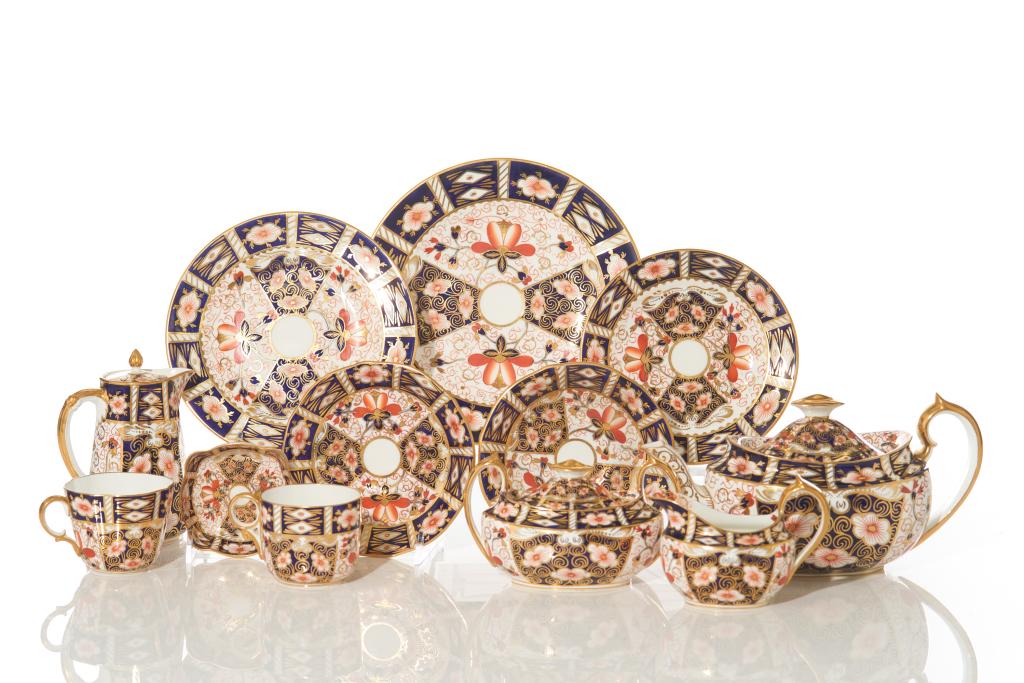 ROYAL CROWN DERBY TEA SERVICE: Made in England 1927, "Old Imari" pattern with stamp marks on the bottom of each. Fifteen cups and saucer pairings, teapot, milk, creamer, sugar, small condiment dish, eight luncheon plates, eight sal