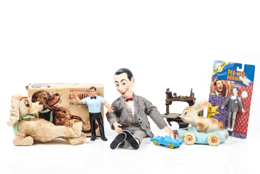 LOT OF TOYS: Including cast iron mechanical banks, robots, a miniature Singer sewing machine, battery operated animals, PeeWee Hermans, etc.