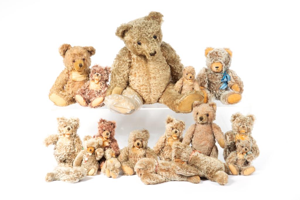SEVENTEEN VINTAGE STEIFF TEDDY BEARS: Various sizes. All Zotty bears with glass and beaded eyes, some with reticulated arms and legs, some with original ear tags. Worn with some signs of repair. H. 28 in. (largest)
