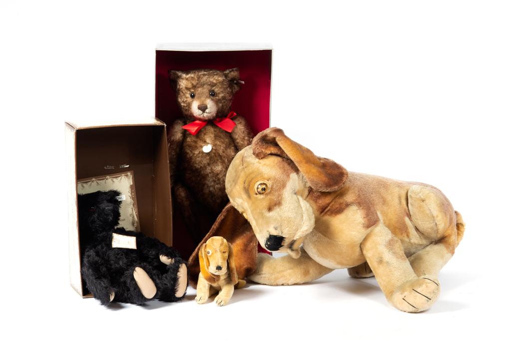 FOUR STEIFF STUFFED TOYS: Including an oversized and small basset hound, and two replica bears from 1912 and 1926 with original boxes.